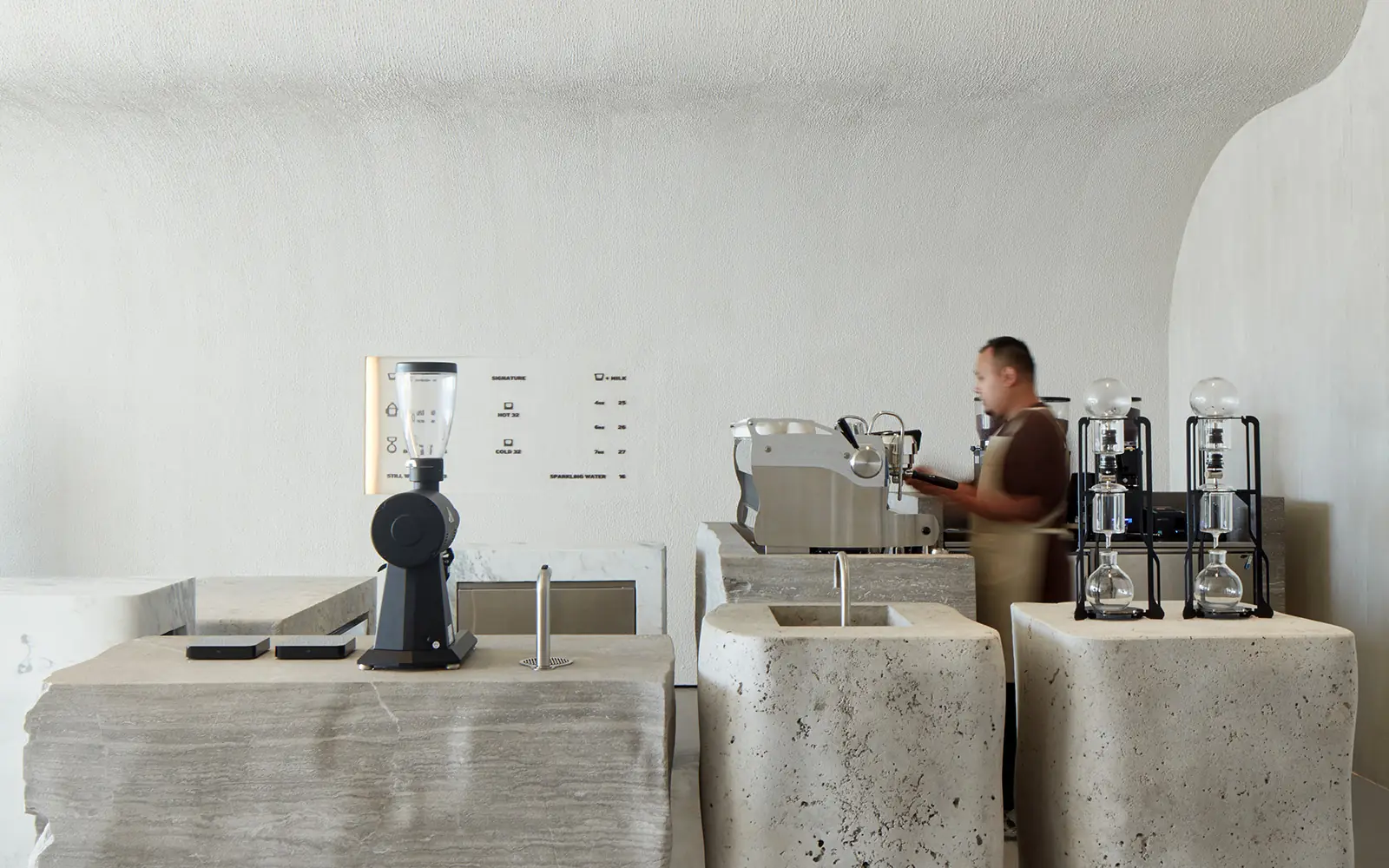The Orijins lounge with stone seating and soft daylight